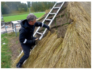 person and thatched roof
